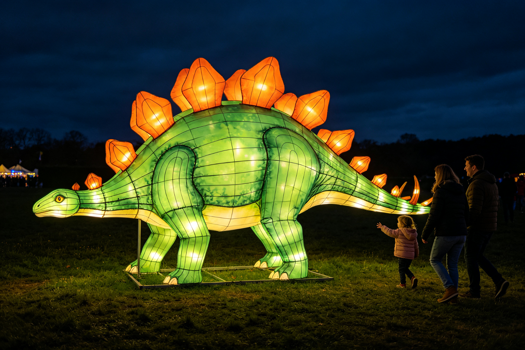 Green stegosaurus lantern with orange back plates at festival with family