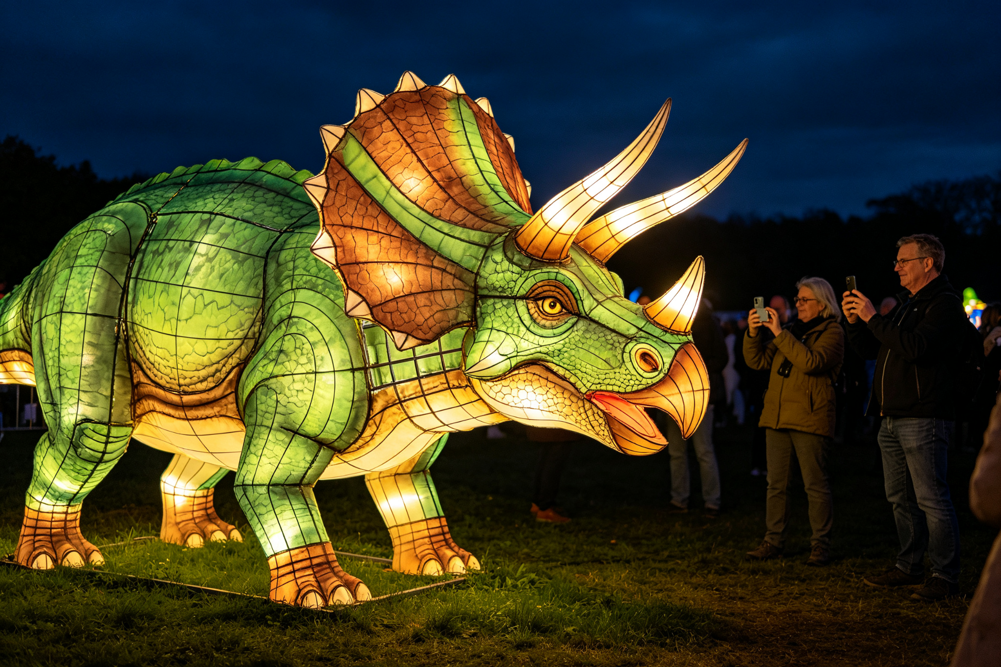 Green and brown triceratops lantern with three horns at festival with tourists